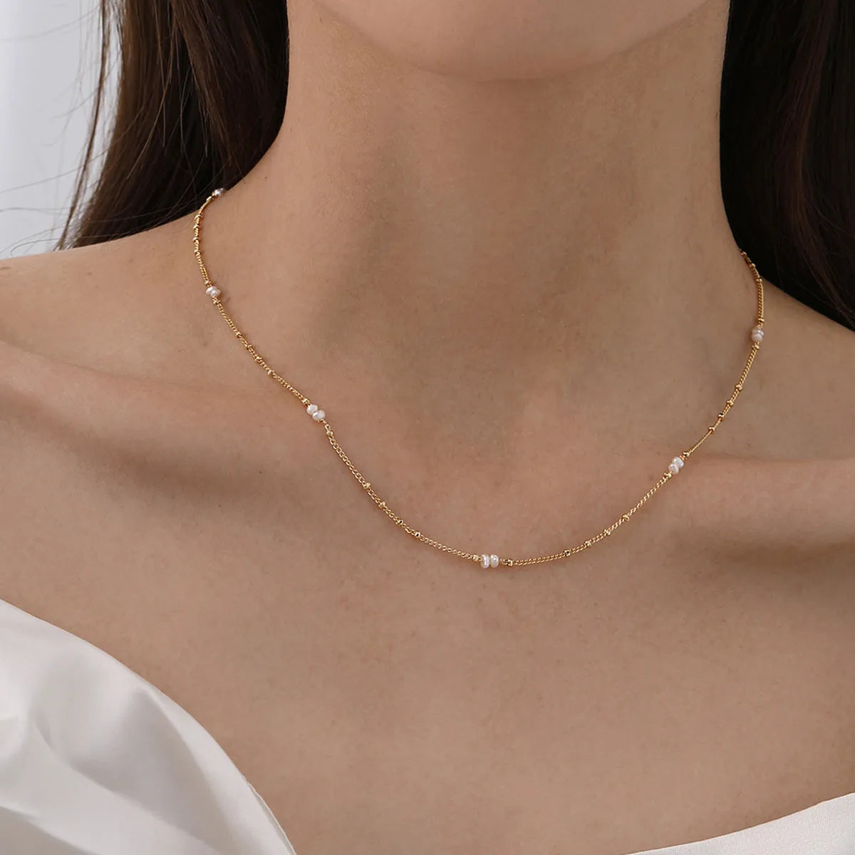 Natural pearl shell pendant necklace with adjustable copper chain on a neutral background