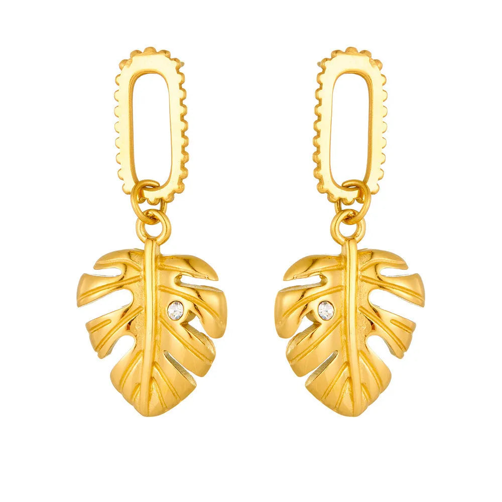 Heart shape titanium steel earrings in gold leaf style on white background