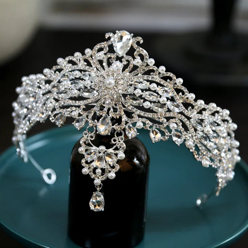 Silver alloy baroque bride crown with pearl and quota decoration on a white background