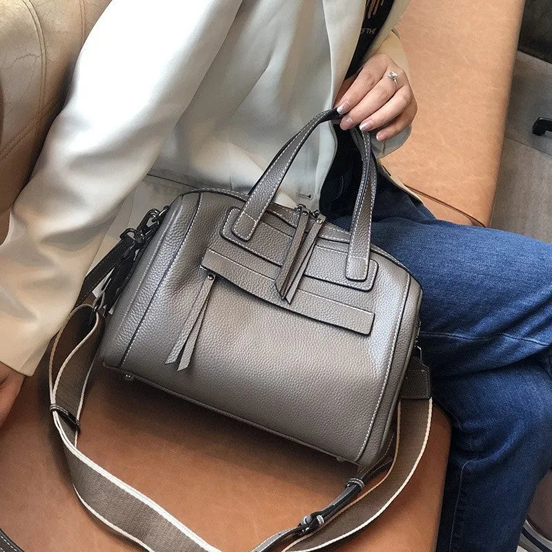 Genuine leather messenger bag with Boston lychee pattern stitching showing horizontal square shape and shoulder strap