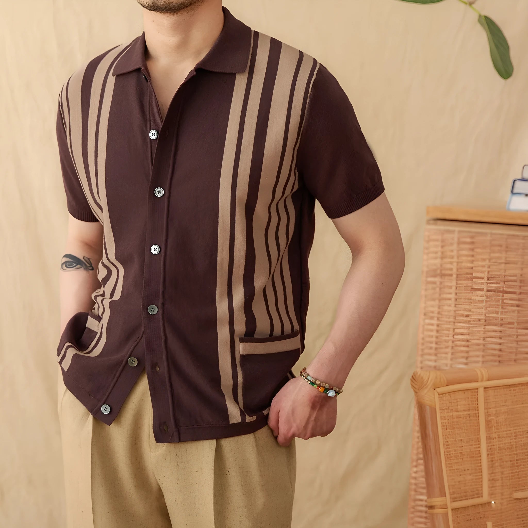A man's short-sleeved striped cardigan polo shirt with a lapel collar, shown in a light blue colour.
