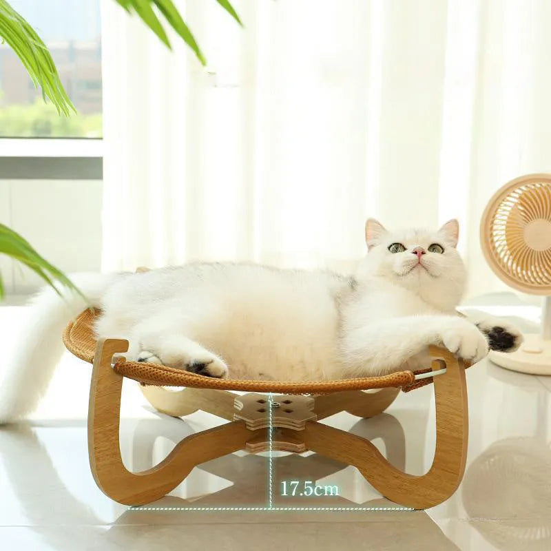 Brown square woven rattan raised hammock bed for cats and dogs on a wooden floor.