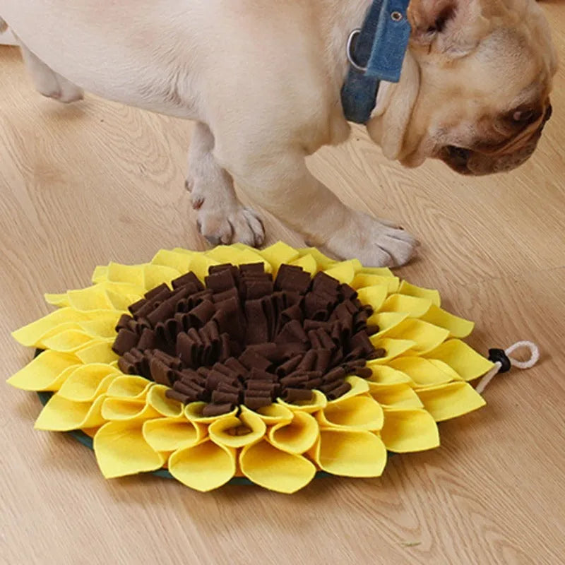 Yellow sunflower-shaped dog snuffle mat with fleece texture and a hanging rope buckle.