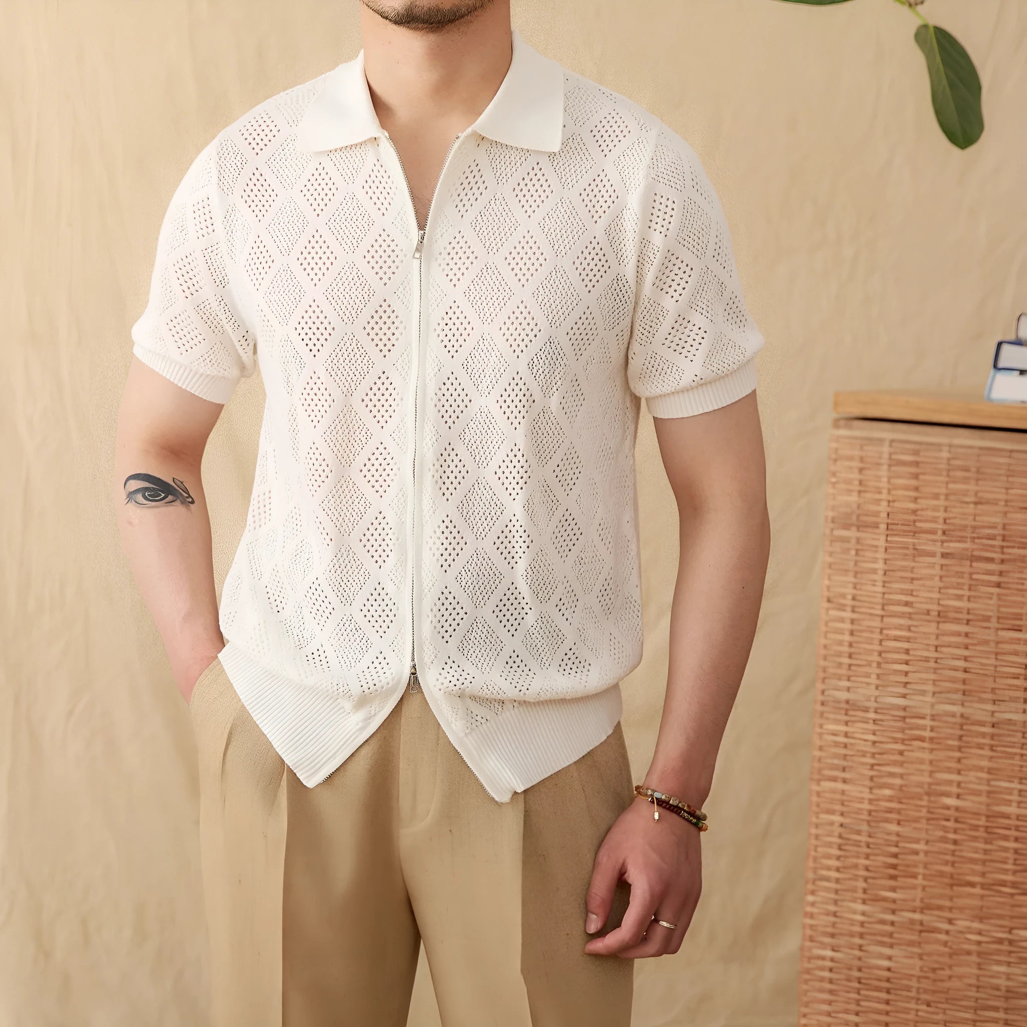 Light brown cotton short sleeve cardigan with zip front and lapel collar on a hanger