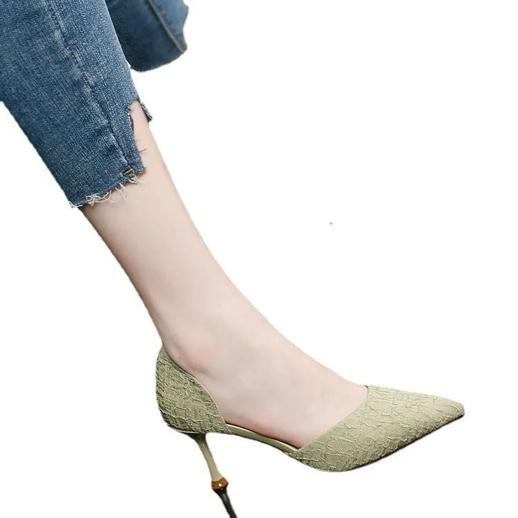 Women's black pointed toe stiletto high heels with PU leather upper on a plain background.
