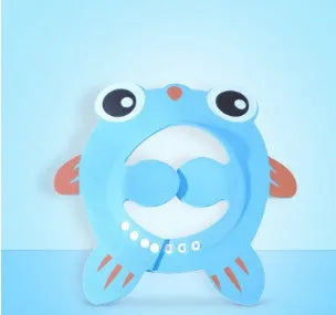 Blue baby shower cap with cartoon ear protection on a toddler's head during bath time