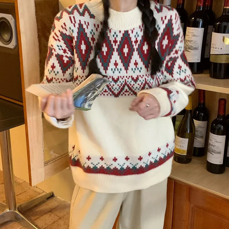 Red and white striped loose retro-style long sleeve pullover knitted top on a hanger.