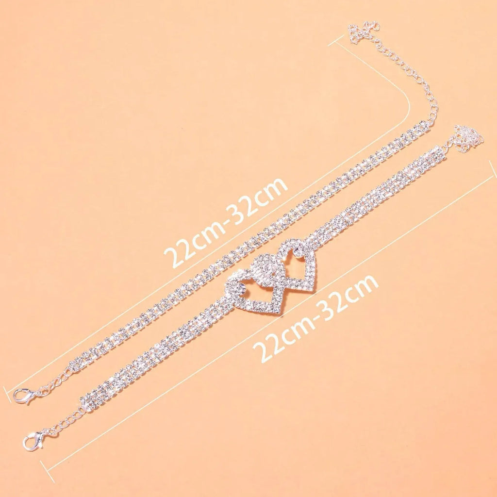 Set of two alloy double heart anklets with electroplated finish, unisex style, displayed together