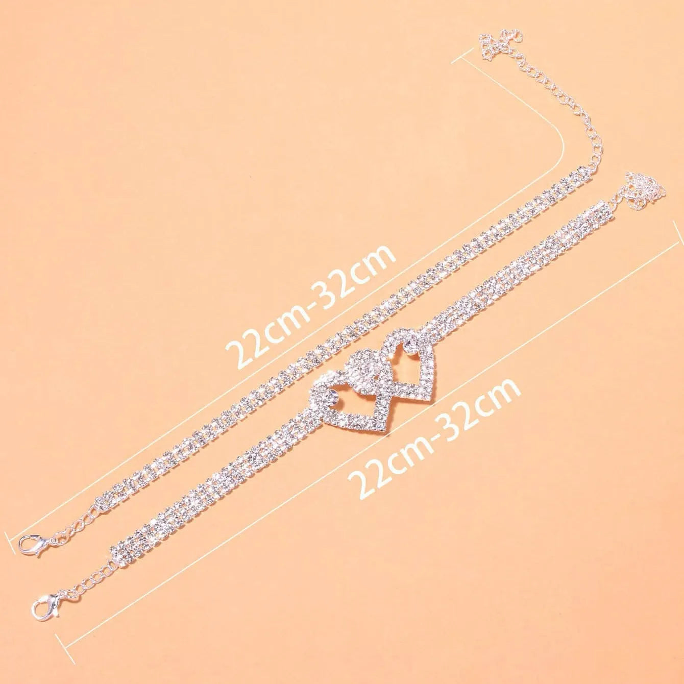 Set of two alloy double heart anklets with electroplated finish, unisex style, displayed together