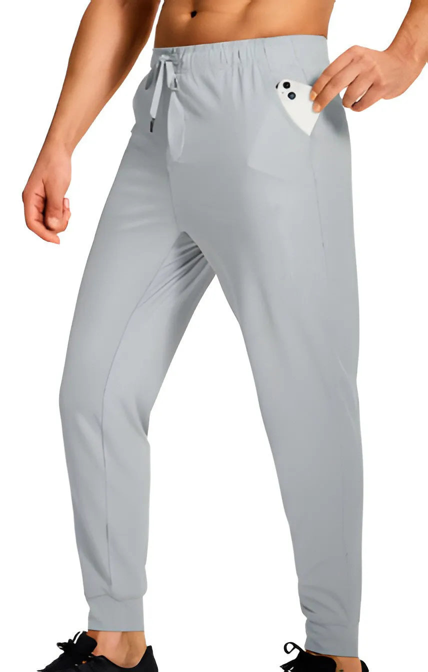 Men's loose-fit solid colour casual trousers made from polyester fabric on a hanger.