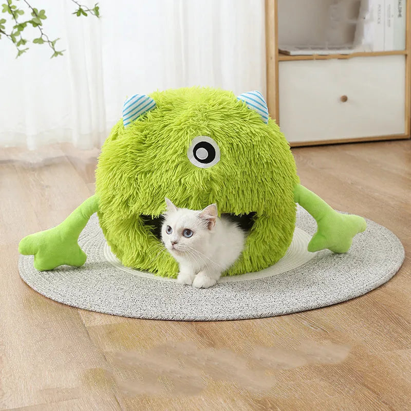 Round fluffy plush cat bed on a floor, showing its non-slip base, next to a resting cat.