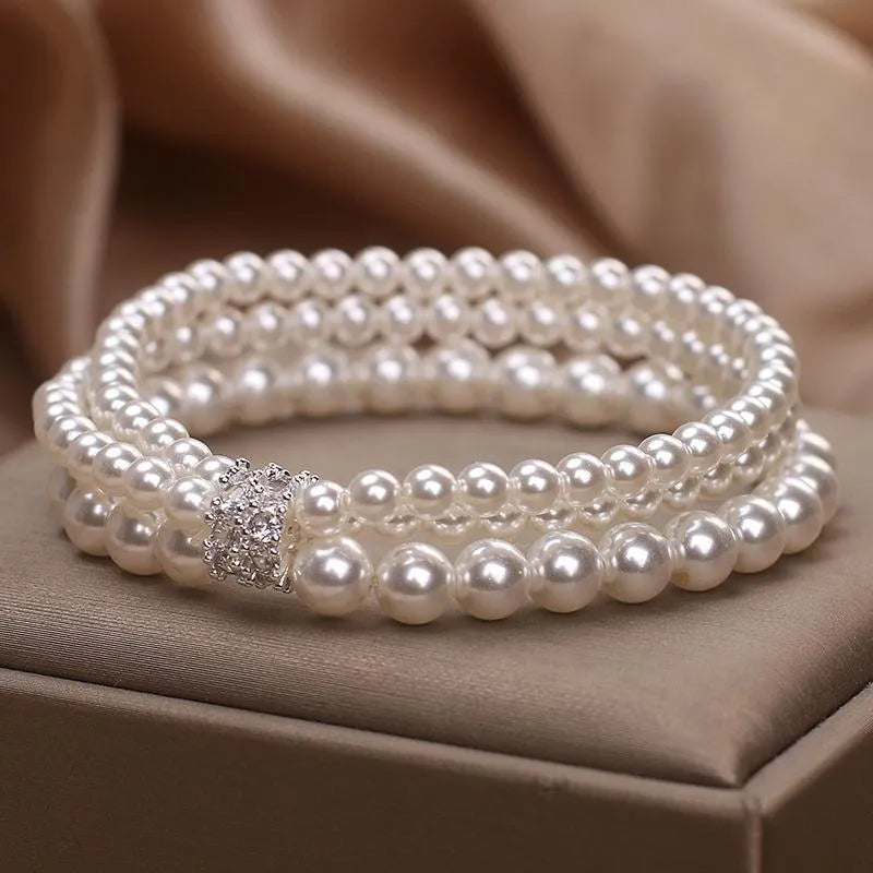 Baroque pearl multi-layer twin bracelet in white with electroplated finish on neutral background