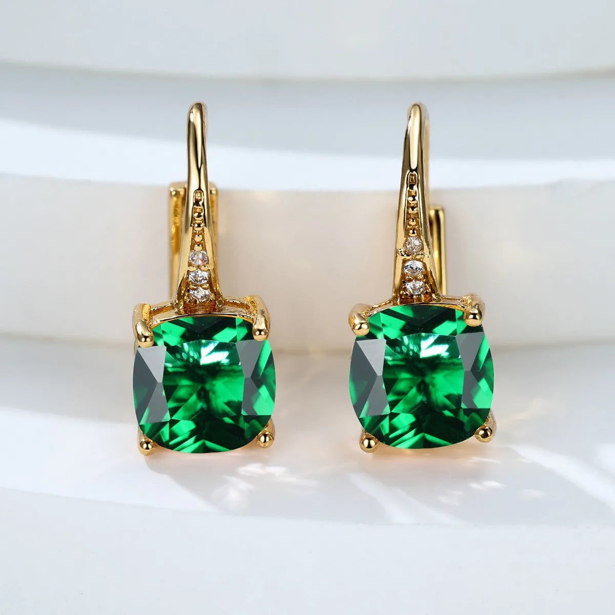 Square geometric ear hook studs with a round zircon stone, shown in a gold electroplated finish.