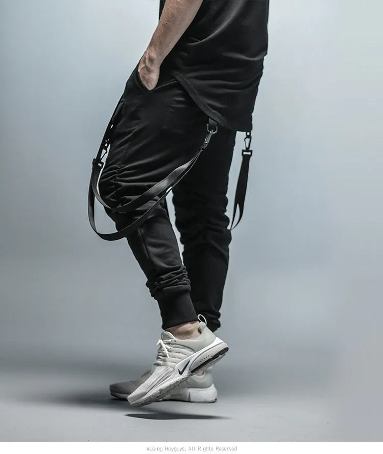Black cotton blend men's hip hop pencil sweatpants with belt lying flat