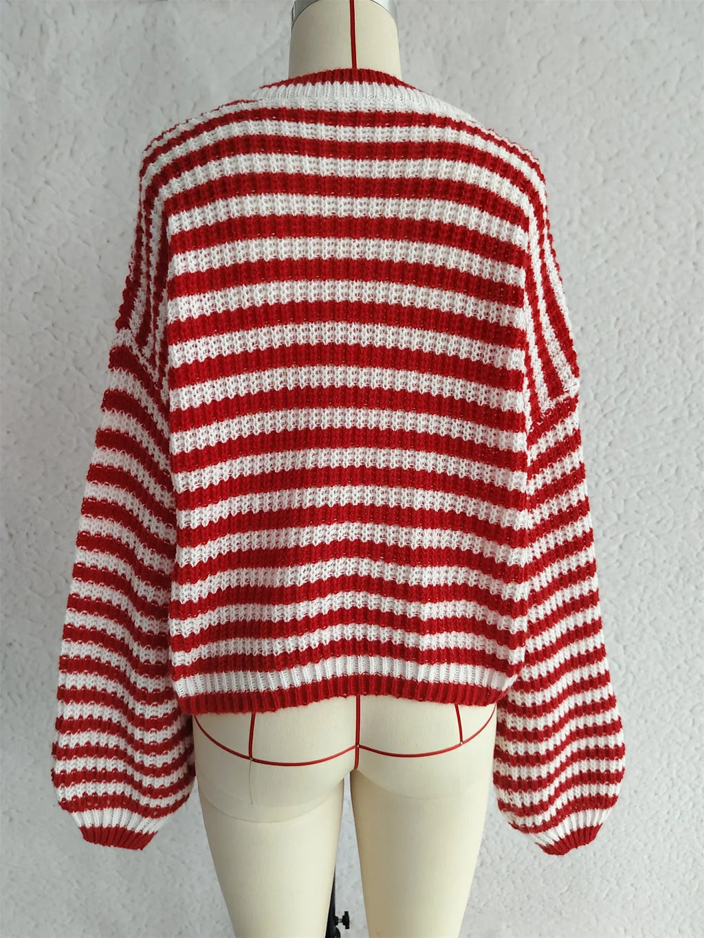Woman wearing a vintage striped loose-fit pullover sweater in a khaki colour.