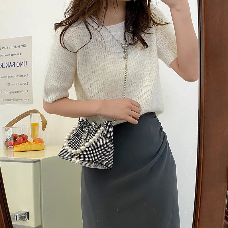 Light diamond pattern shoulder bag with western style chain crossbody and bucket shape design