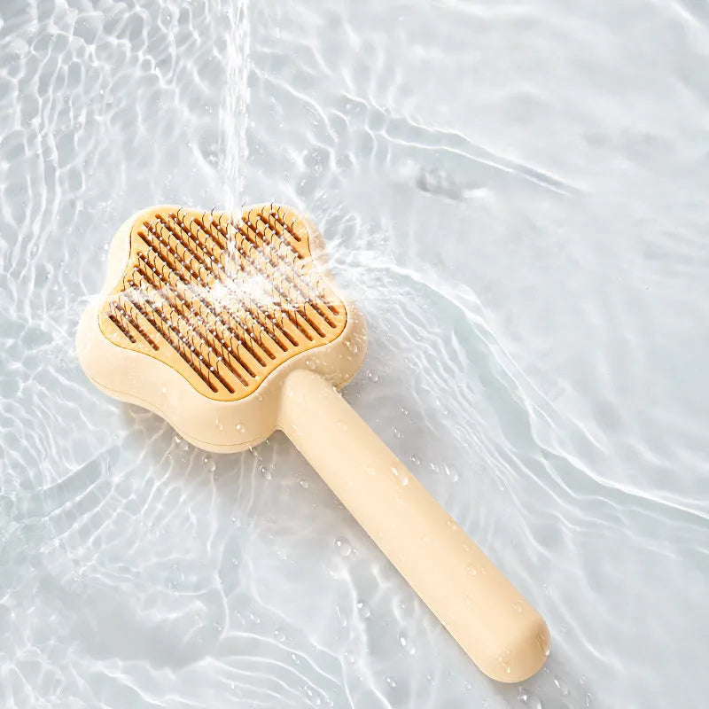 Large green self-cleaning cat comb magic wand with stainless steel needle teeth for pet grooming.