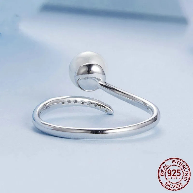 Open loop adjustable sterling silver ring with a white shell pearl.