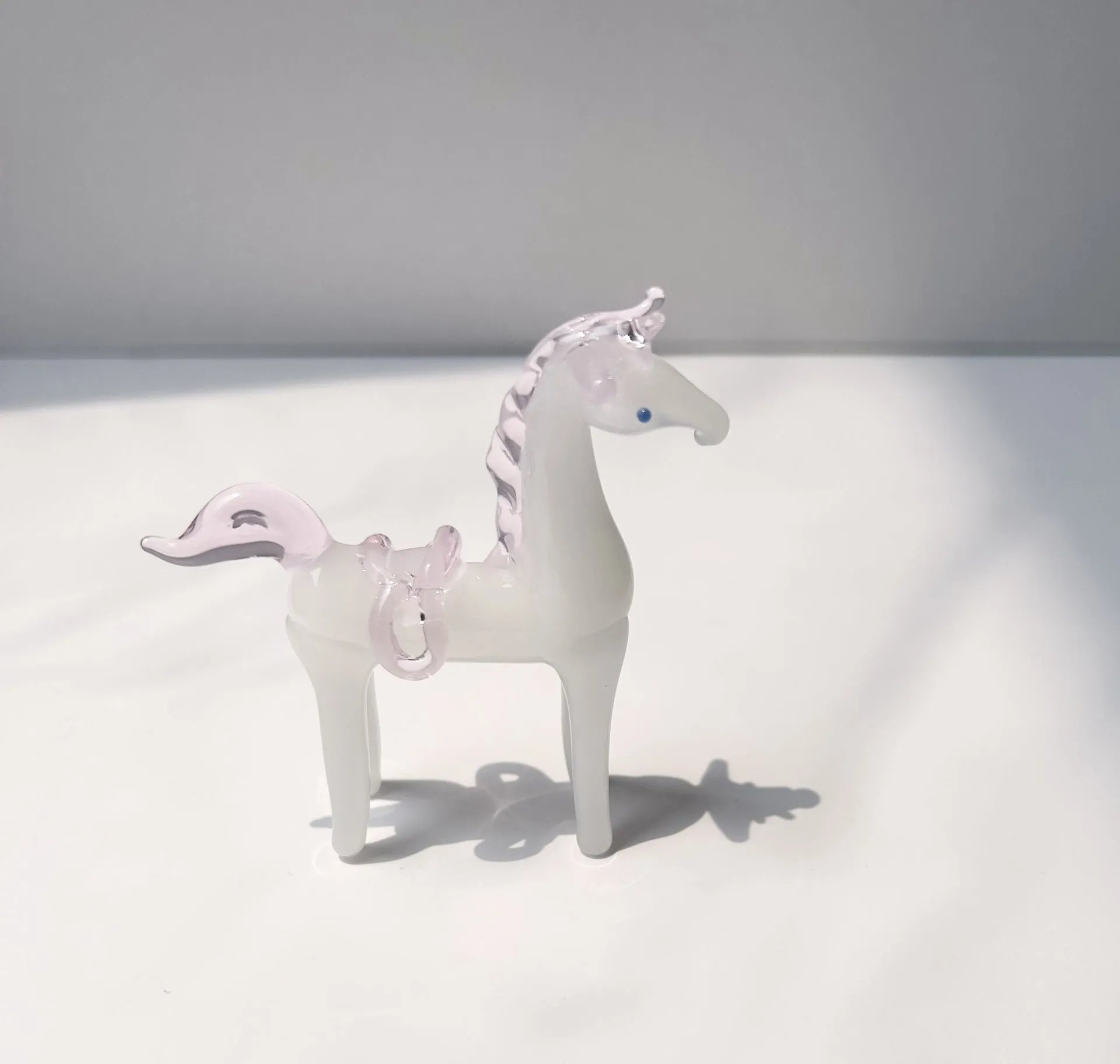 Brown glazed ceramic horse ornament on wooden shelf