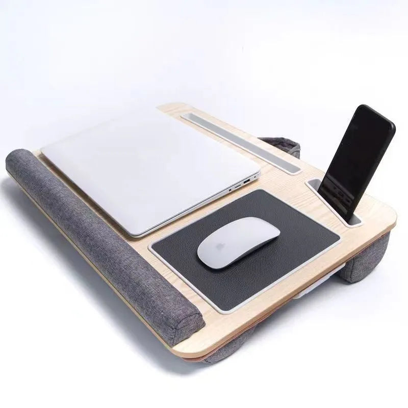 Foldable laptop desk in black walnut colour on a bed with laptop open