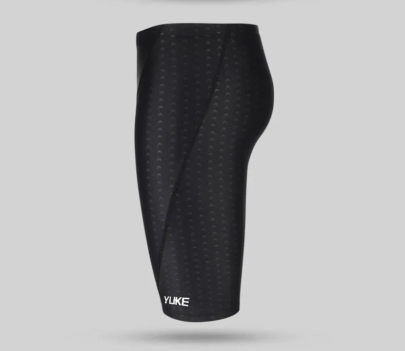 Men's black five-piece swimming set including trunks, goggles, cap, ear plugs, nose clip, and carry bag laid out flat.