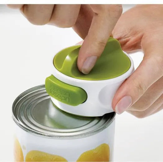 Compact manual can opener with stainless steel blade and ABS plastic body on a kitchen counter