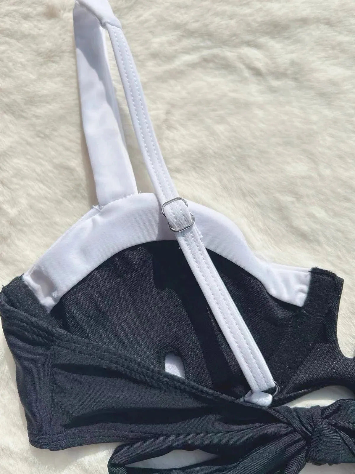 Women's black low waist bikini swimsuit with stitching detail and split leg design