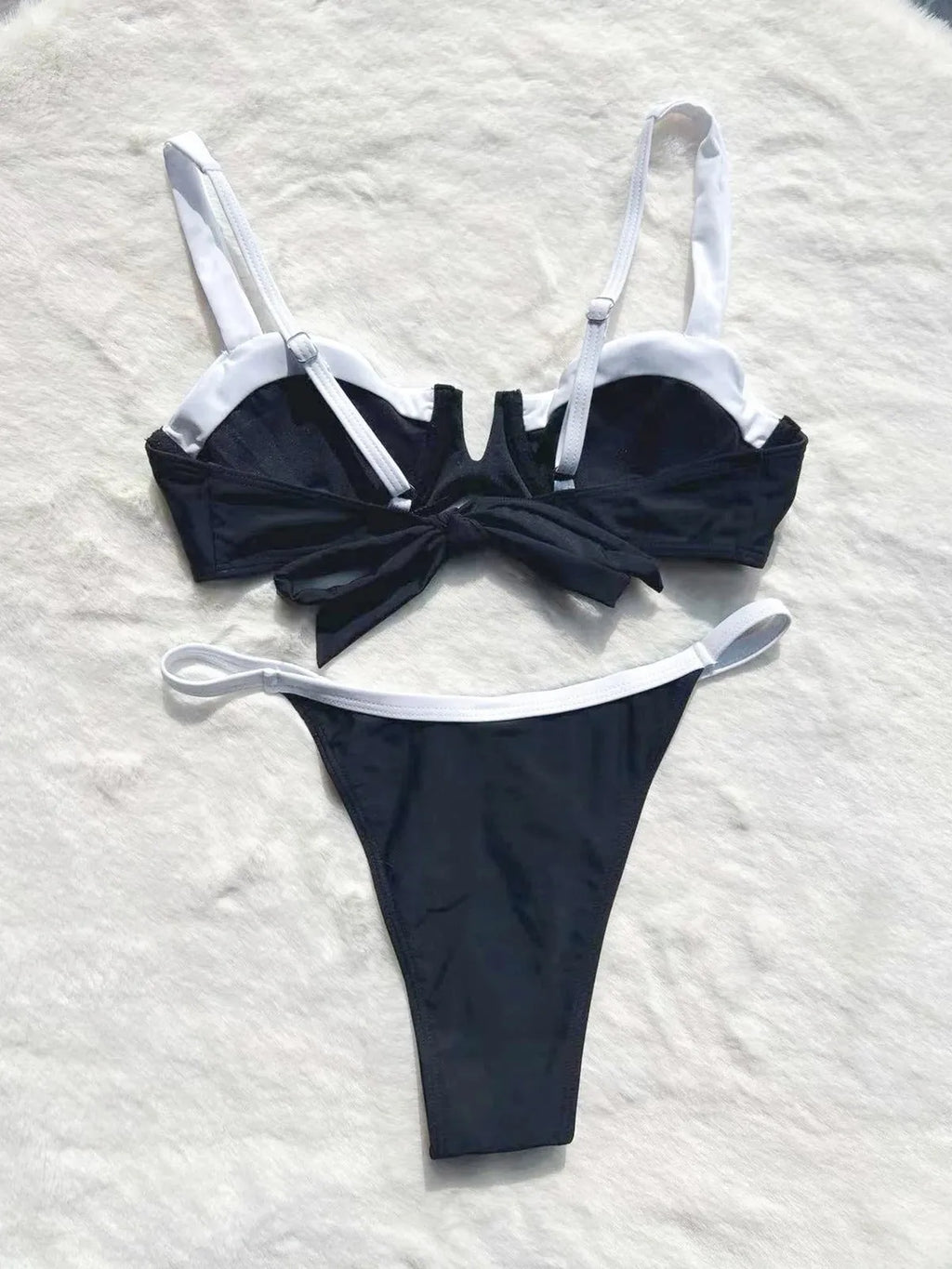 Women's black low waist bikini swimsuit with stitching detail and split leg design
