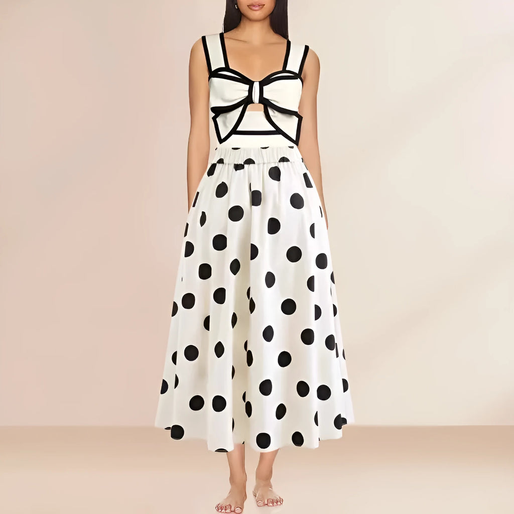 Women's black one-piece swimsuit with a white bow and attached round skirt.