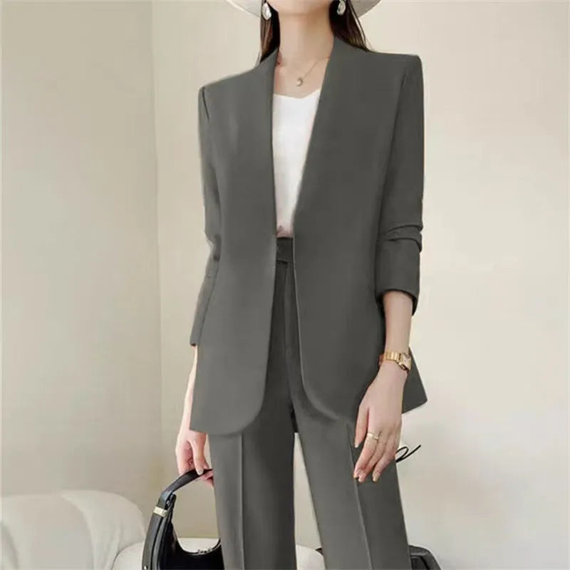 Women's polyester business suit set with blazer and trousers in beige, model standing