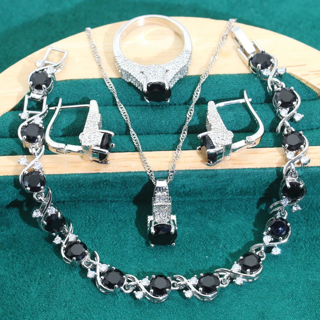 Bridal zircon four-piece jewellery set showing necklace, bracelet, earrings and ring with alloy pendant material