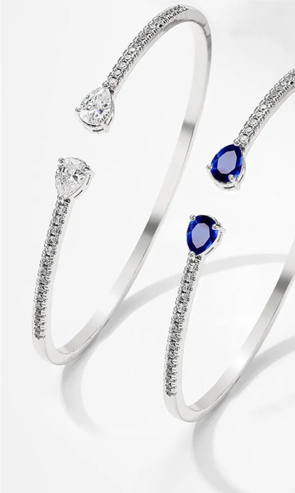 Copper bracelet with multi-zircon inlay in simple style, shown in white and blue colour options.