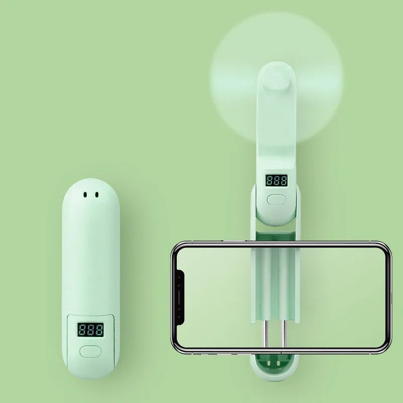 Green folding mini fan with plastic leaves, shown open and closed to show compact design.