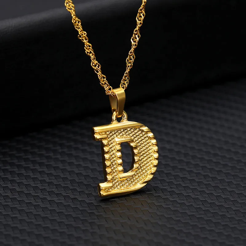 Gold-plated alloy initial pendant necklace with 42cm chain on white background