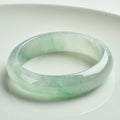 Light green jade bracelet showing natural stone material and simple design for unisex wear