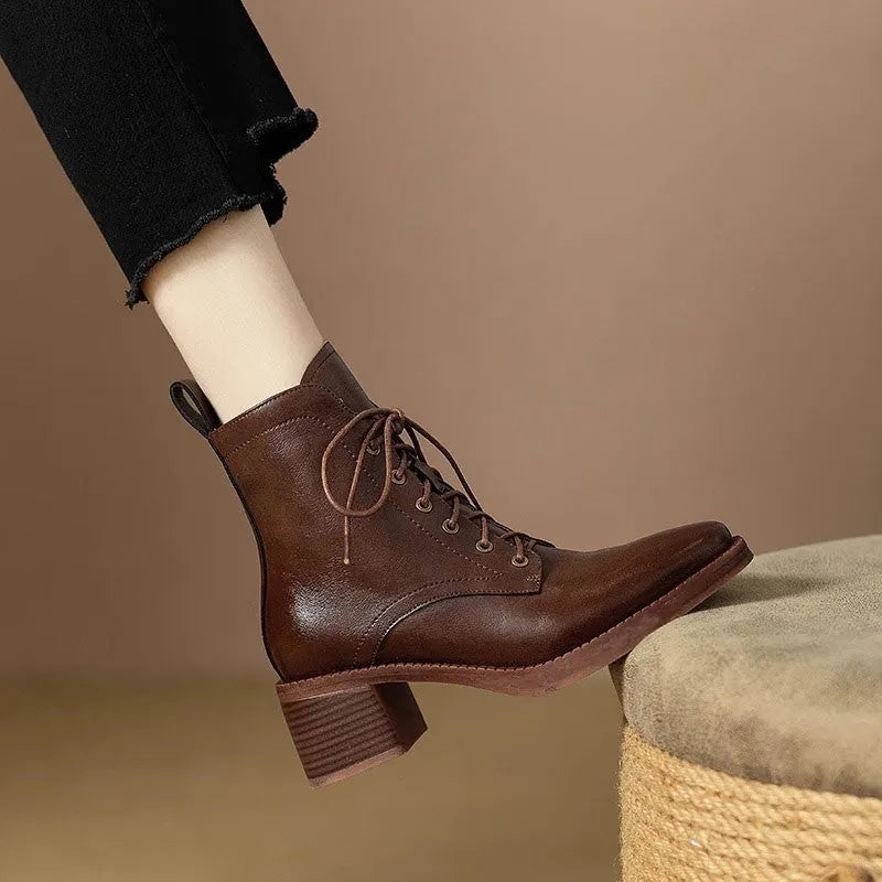 Women's black pointed-toe short tube boots with a 5.5cm heel on a plain background.