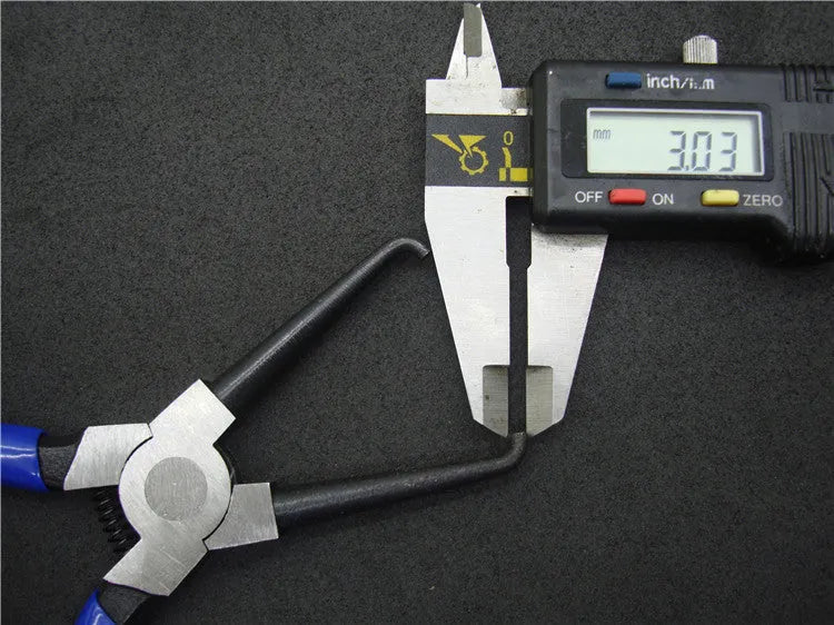 Iron caliper tubing pliers with rubber-coated handles and specialised jaws for fuel line connectors.