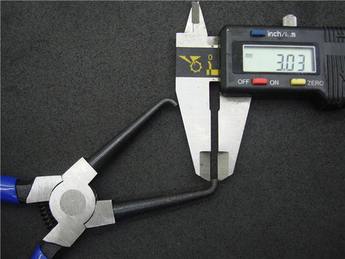 Iron caliper tubing pliers with rubber-coated handles and specialised jaws for fuel line connectors.