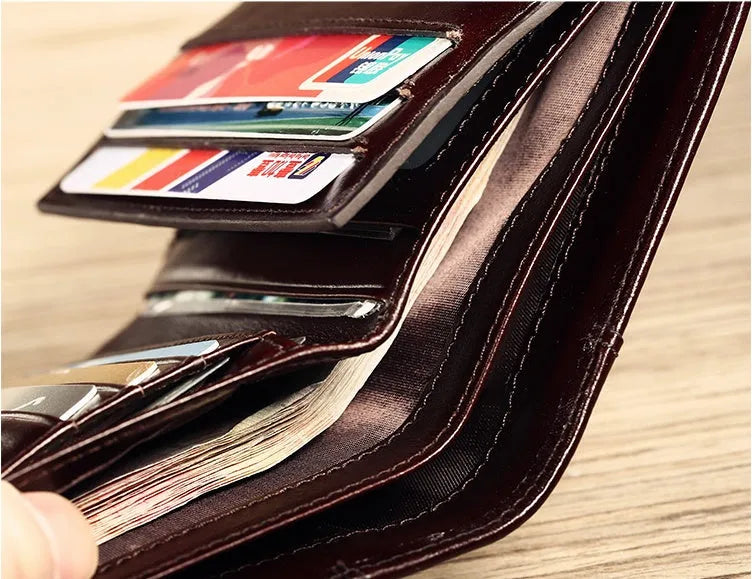 Men's leather wallet showing internal compartments for cards, cash, coins and documents