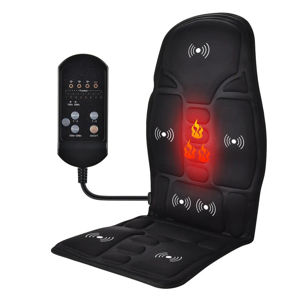 Black electric cervical massager with wireless remote on a table next to international power plugs.