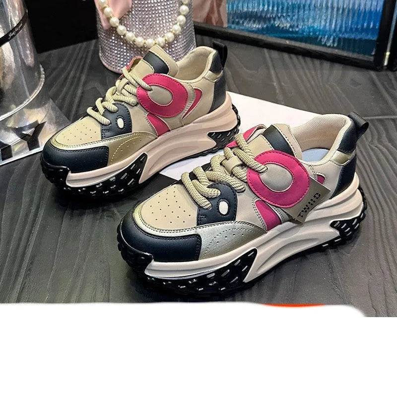 A pair of thick-soled leather casual shoes with a wedge heel and front lace-up design.