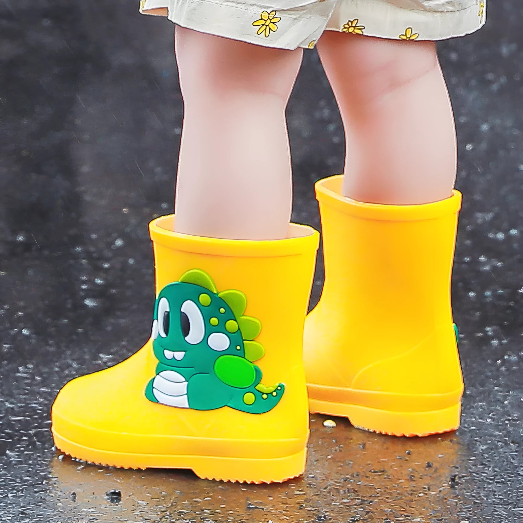 Children's cute waterproof PVC rain boots with cartoon dinosaur pattern in blue, pink, and yellow