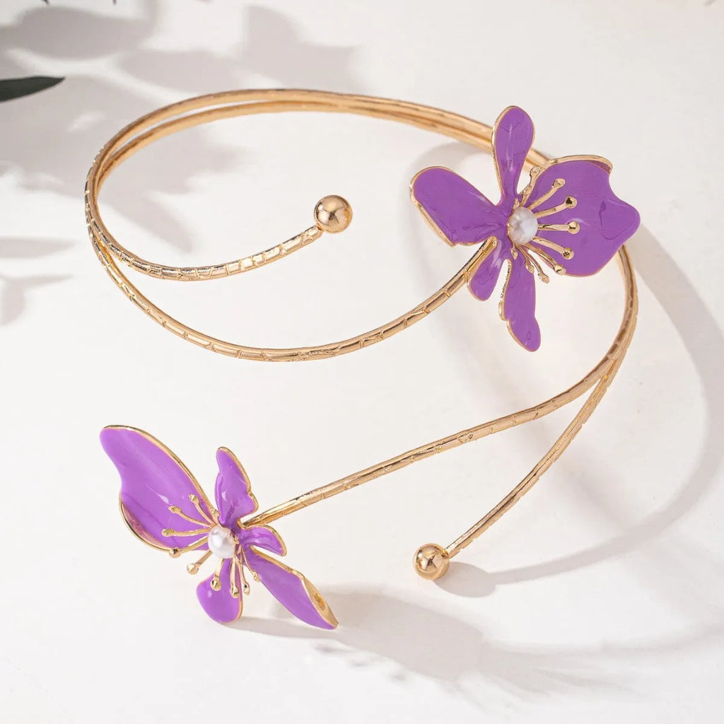Close-up of a geometric hollow pattern alloy armband bracelet in pink, showing adjustable closure.