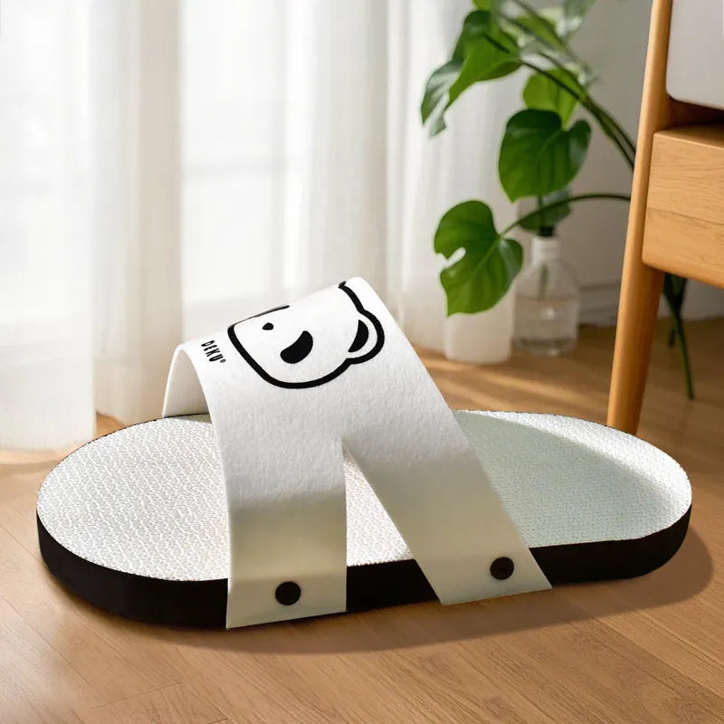 White corrugated paper cat scratch board in slipper style design on flat surface