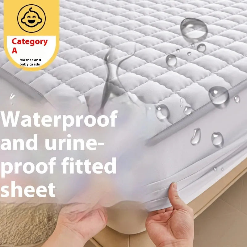 Blue washed cotton fitted sheet with quilted pattern on a bed, showcasing its waterproof protection feature.