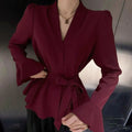 Women's black French-style shirt with irregular collar, long bell sleeves, and a tied front detail.