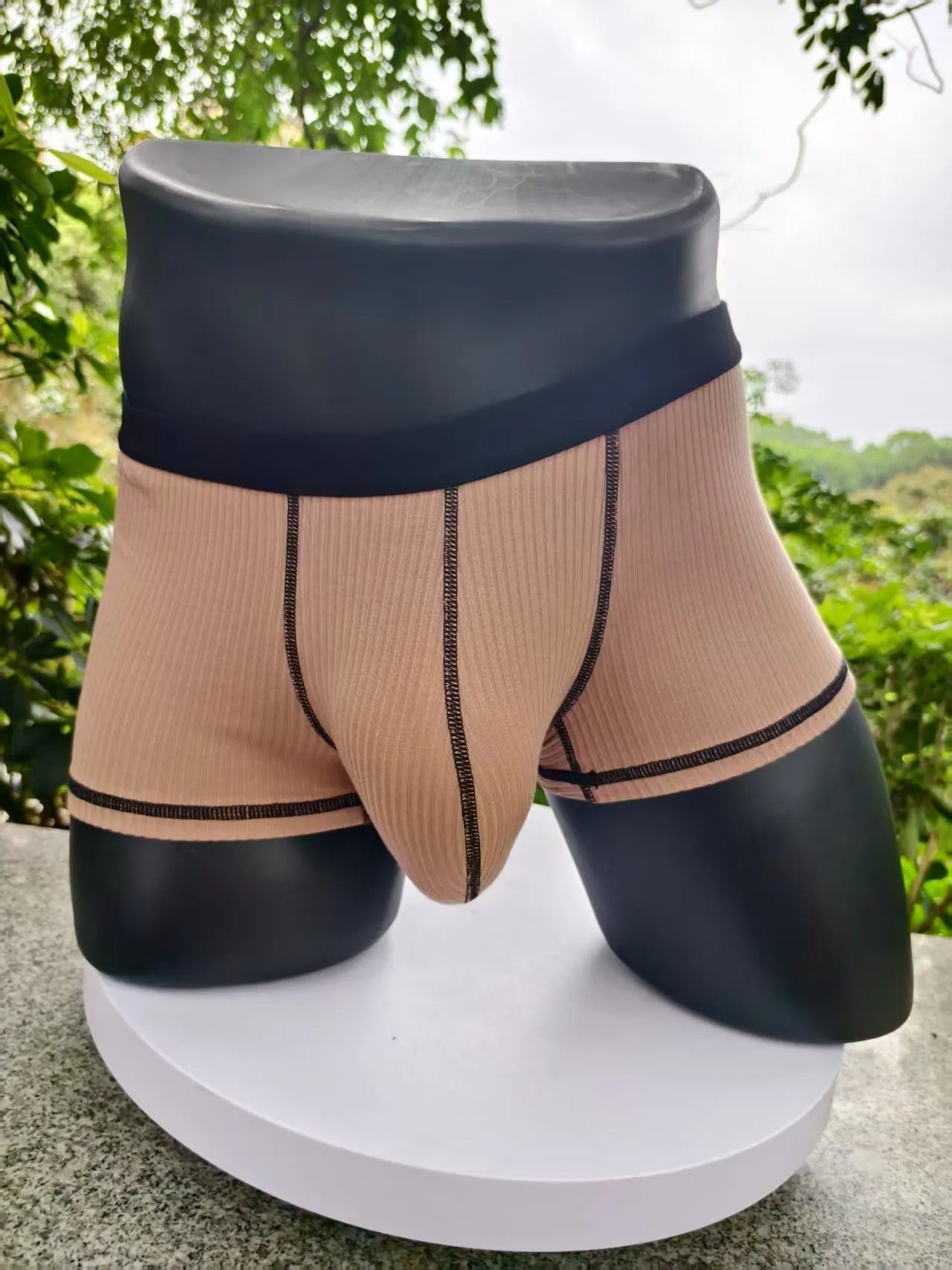 Solid colour men's boxers in breathable thin fabric offering hip lifting and body shaping support.