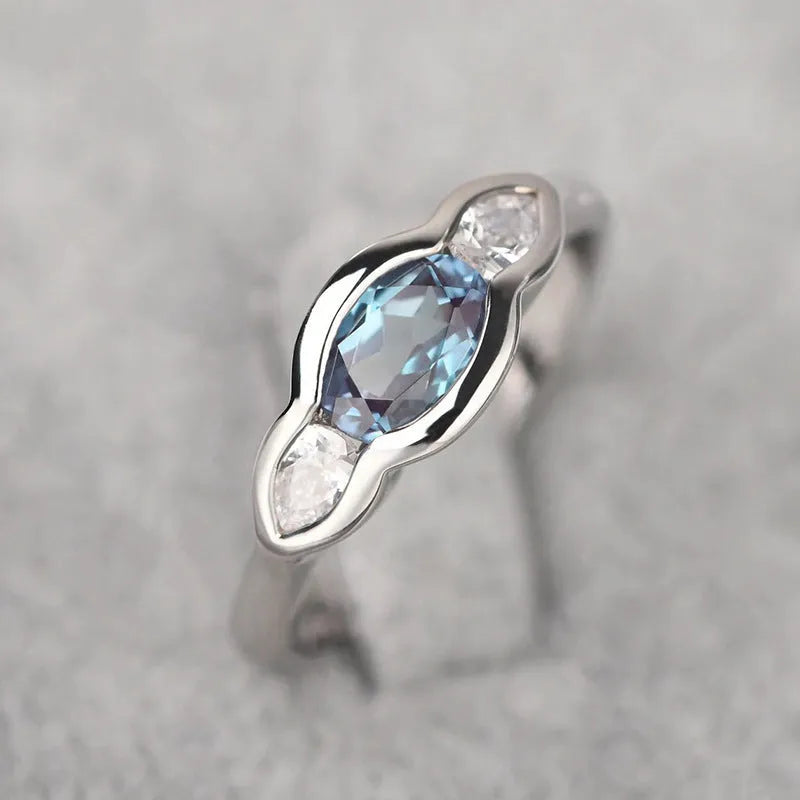 Women's geometric ellipse ring with inlaid zircon stones in white gold tone finish on finger