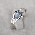 Women's geometric ellipse ring with inlaid zircon stones in white gold tone finish on finger