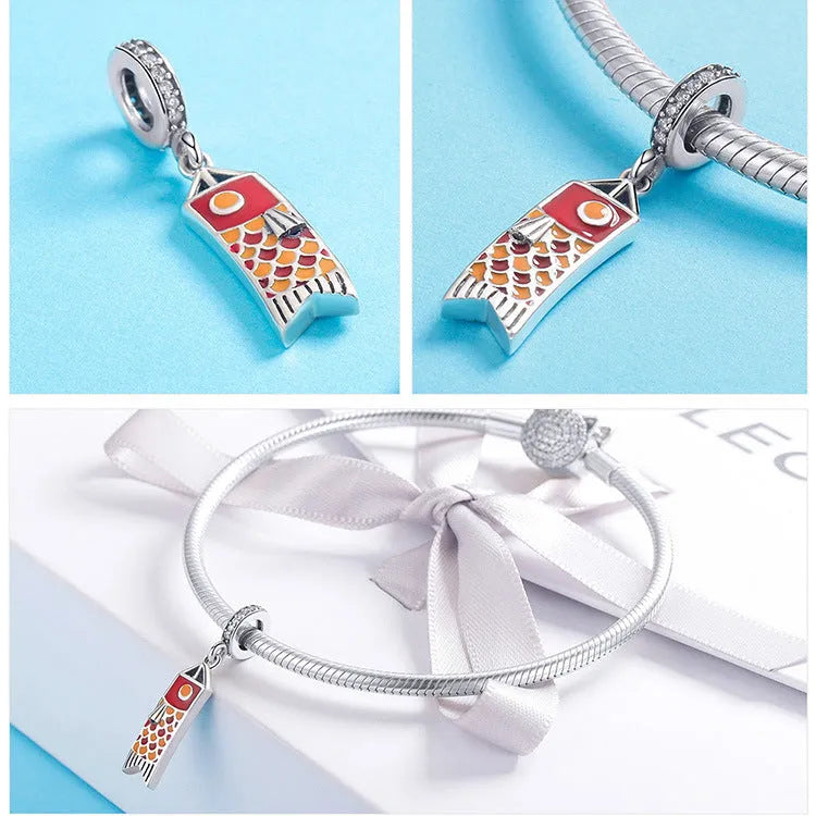 S925 sterling silver carp streamer jewellery charm with zircon stones and oil drop oxidation finish.